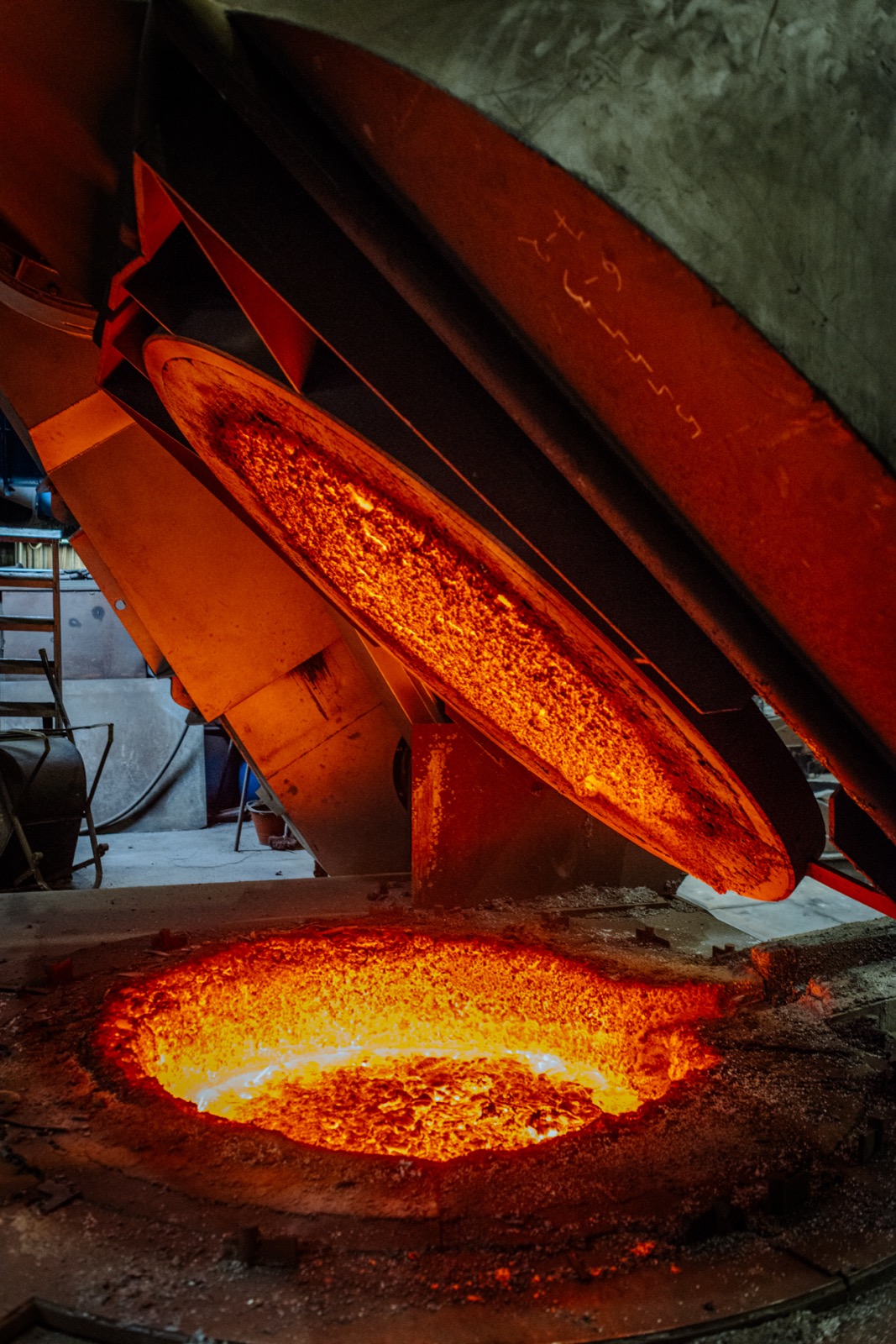CIME coreless holding furnace with the lid swung open and the incandescent bath visible in the foundry